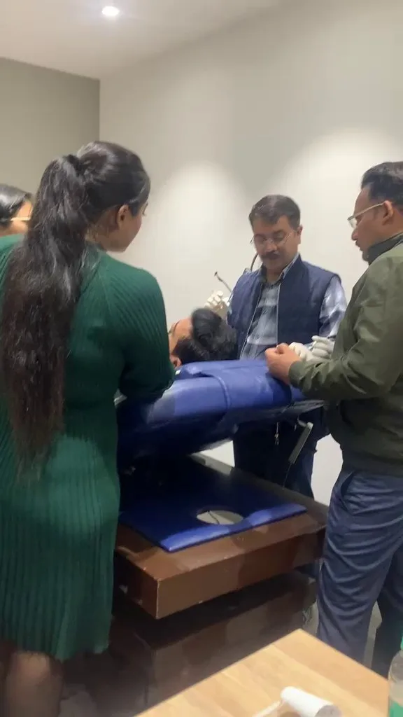 Faculty guiding a hands-on aesthetic training session